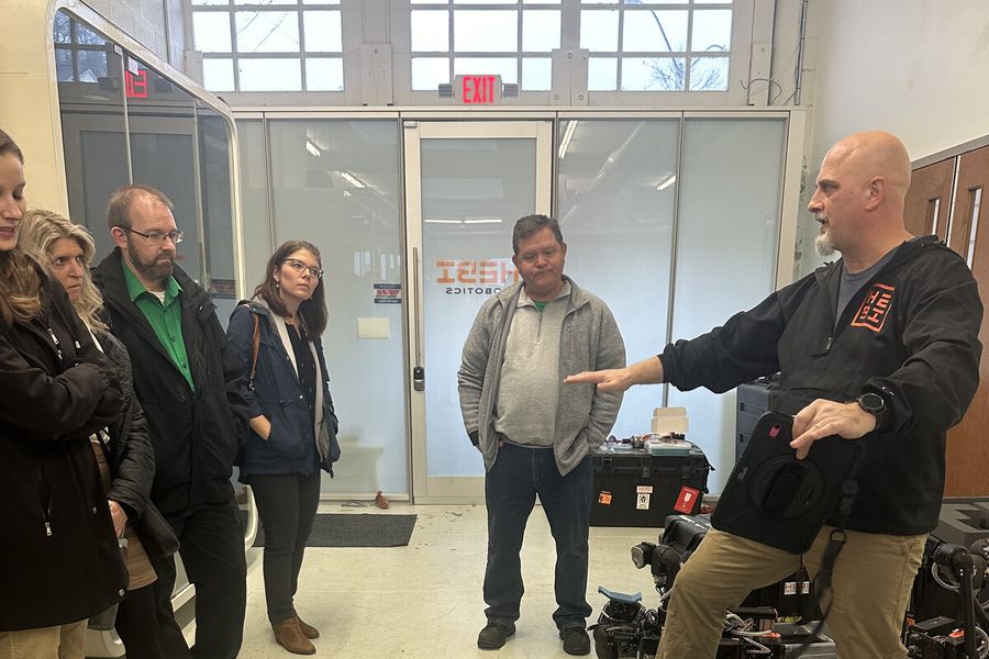 South Fayette educators on a site visit at HEBI Robotics, watching a demonstration of a tracked robotic platform